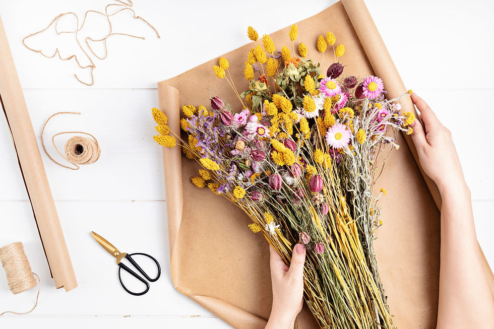 Florist safely wrapping dried flowers for sale.
