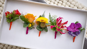 a line of wired button hole bouquets