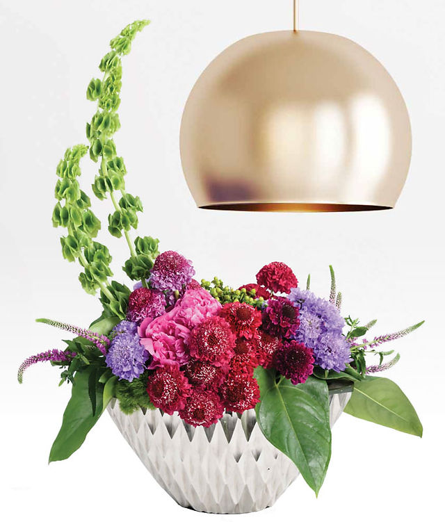 Scabiosa used in a floral design displayed in a white vase
