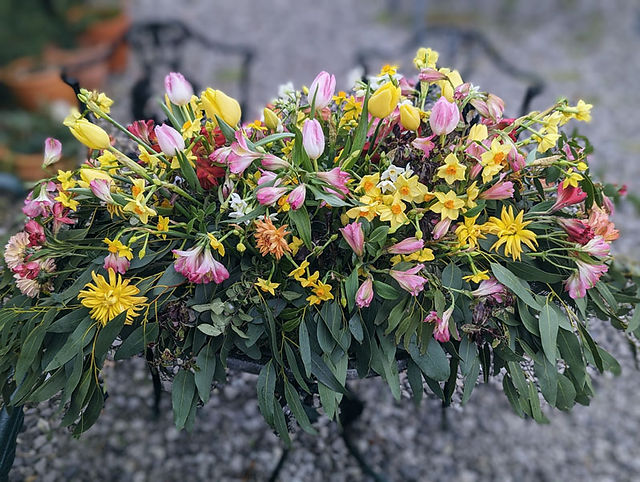 casket spray with pink and yellow