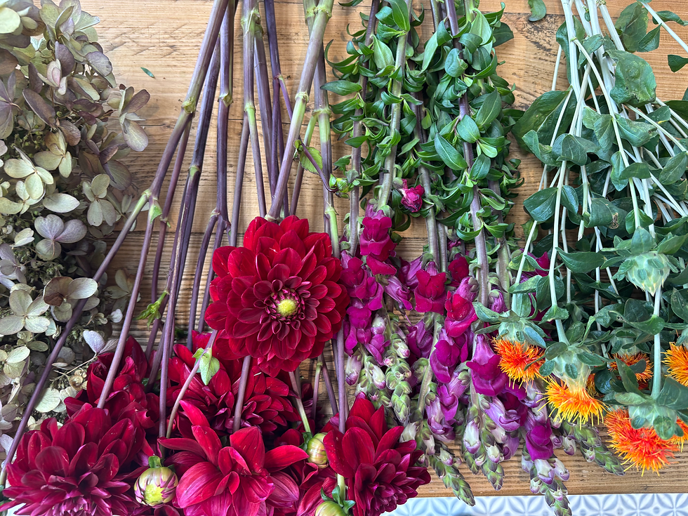 autumnal flowers layered on a table ready to be designed into the latest trend design