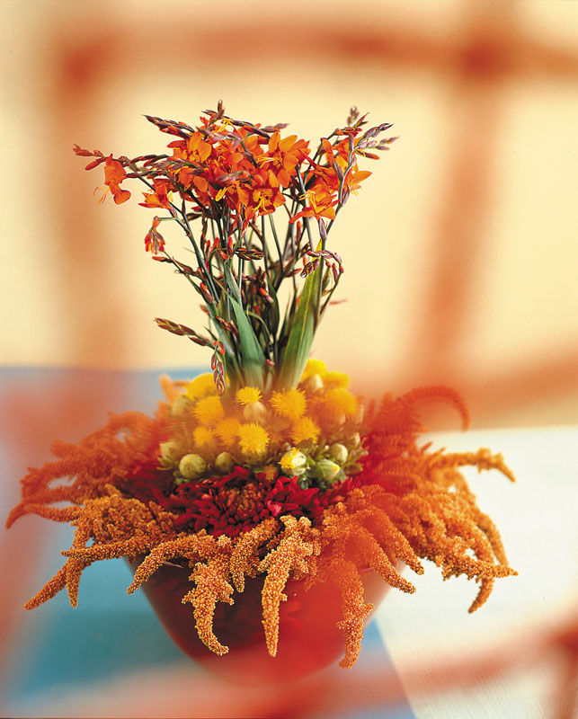 Crocosmia used in an arrangement perfect for a wedding dining table