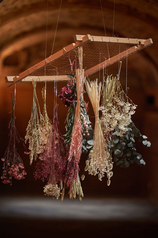 Flowers tied and hanging correctly to dry showing best practice.